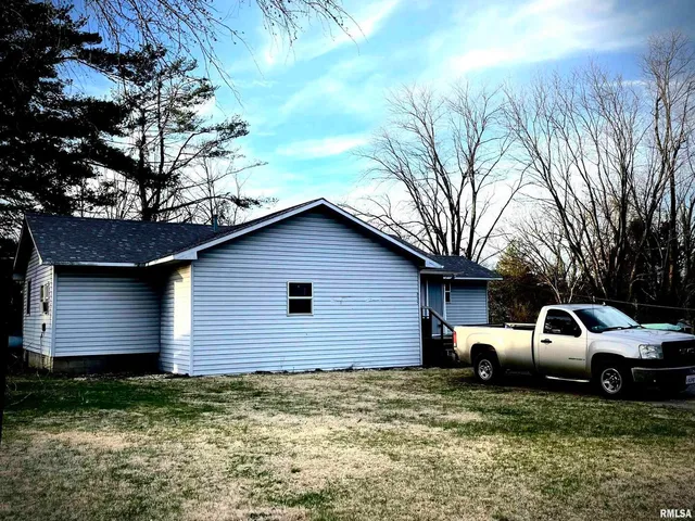 a view of a house with a backyard space
