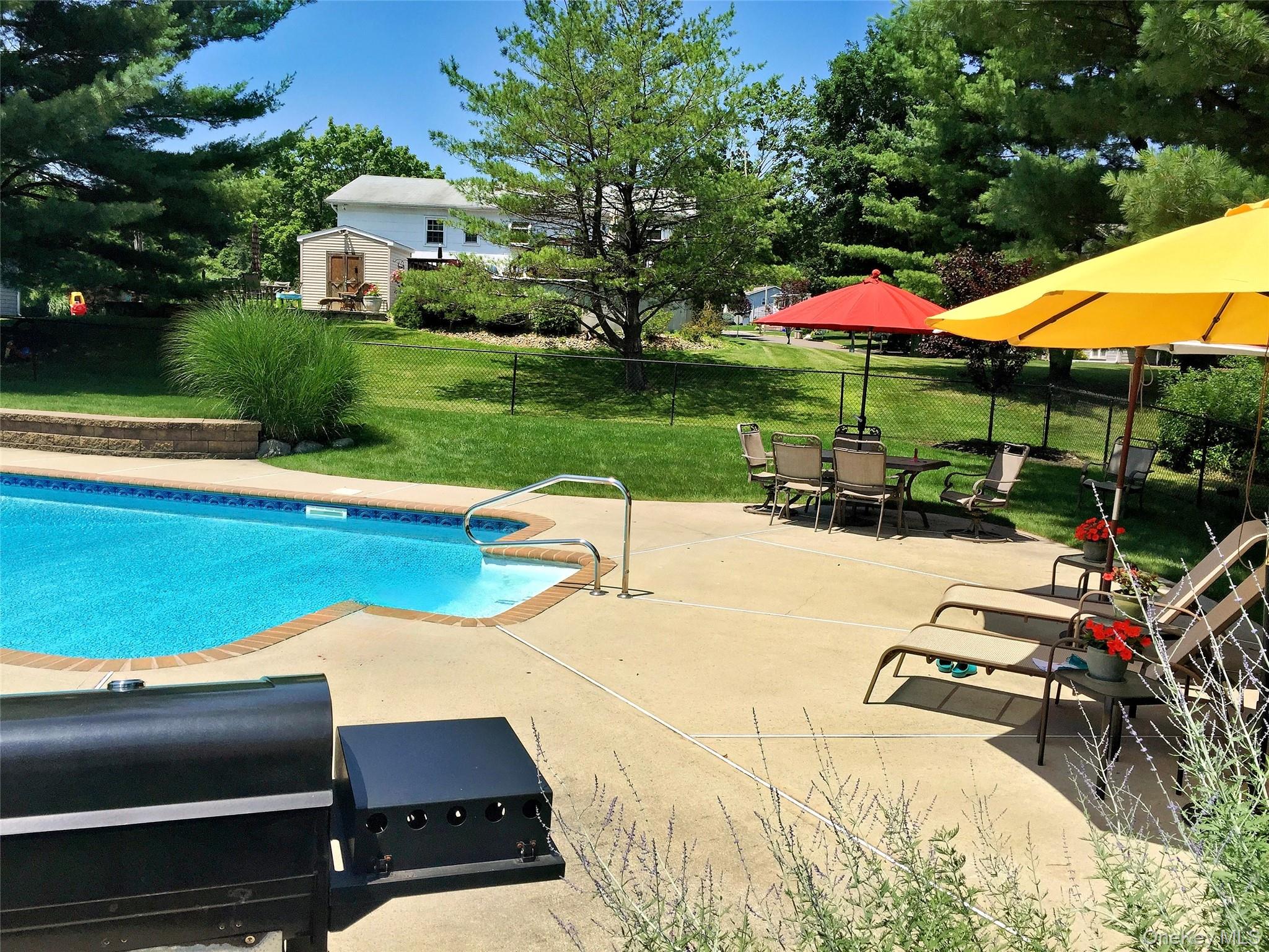 28 Jacobs Road Thiells, NY 10984 - Photo 28 of 29 a view of a patio with a table and chairs under an umbrella