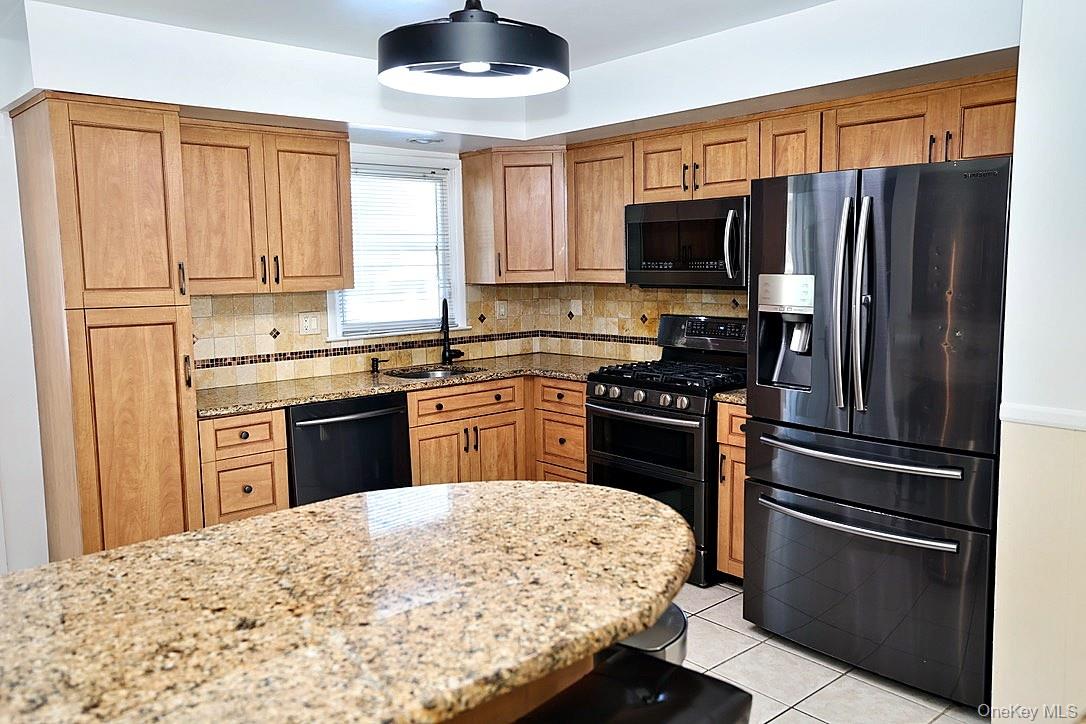 28 Jacobs Road Thiells, NY 10984 - Photo 6 of 29 a kitchen with stainless steel appliances granite countertop a stove refrigerator sink and dishwasher with wooden cabinet