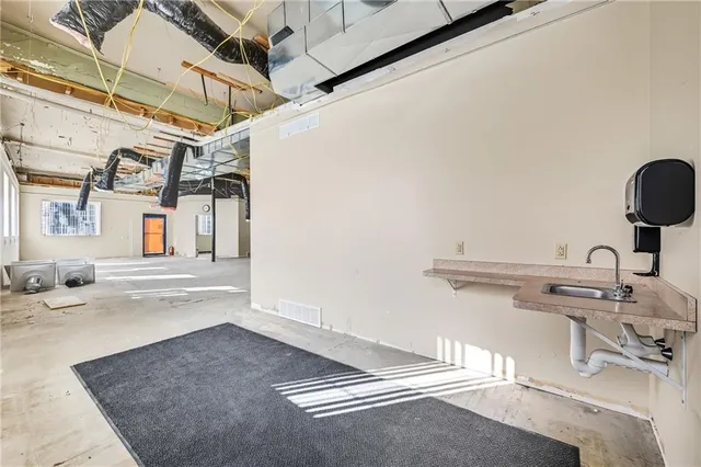 a view of a kitchen with a sink and a window