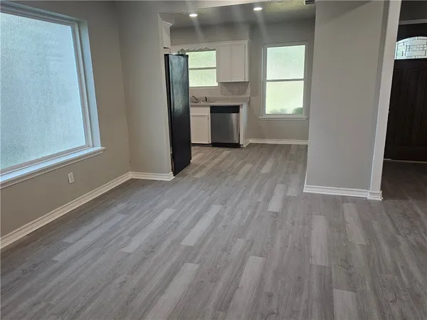 an empty room with wooden floor and closet