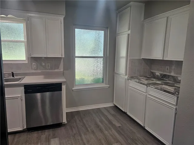 a kitchen with a refrigerator stove and sink