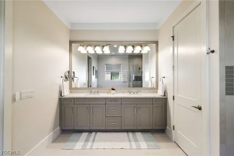 a spacious bathroom with a double vanity sink a mirror and a bathtub
