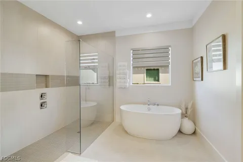 a bathroom with a bathtub and shower