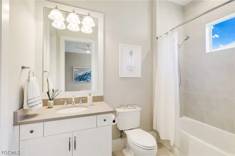 a bathroom with a sink toilet vanity and shower