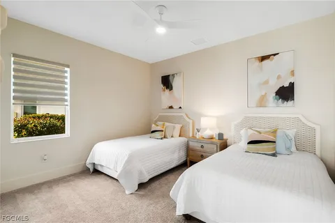 a bedroom with two beds and a window