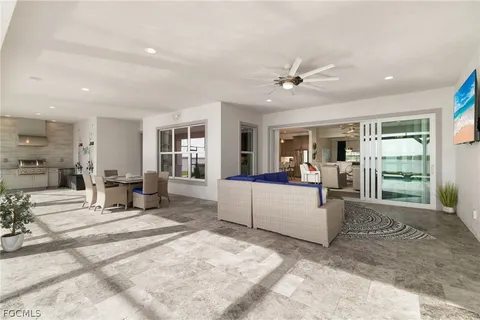 a living room with furniture and a dining table with kitchen view