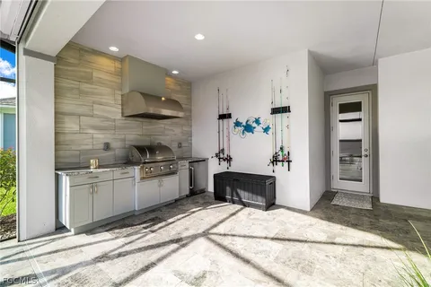 a kitchen with stainless steel appliances kitchen island granite countertop a refrigerator and a sink