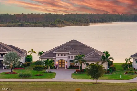a front view of a house with a yard and mountain view