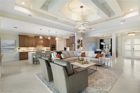 a living room with lots of furniture and kitchen view