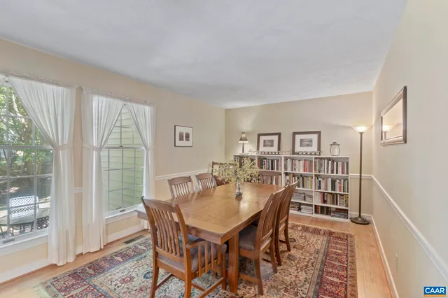 a dining room with furniture wooden floor and a rug
