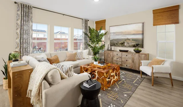 a living room with furniture kitchen and a table
