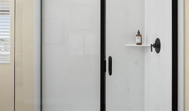 a spacious bathroom with a double vanity sink a mirror and a bathtub