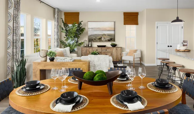 a living room with lots of furniture and kitchen view