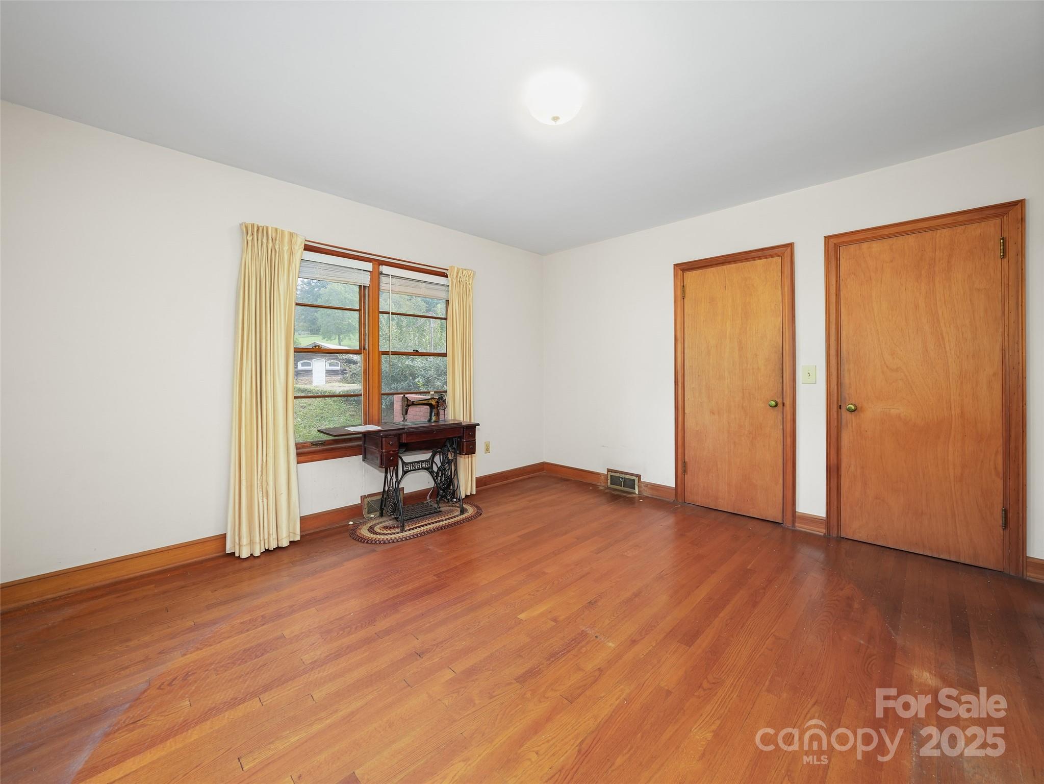 5 Noland Downs Road Waynesville, NC 28785 - Photo 14 of 33 an empty room with wooden floor and a window