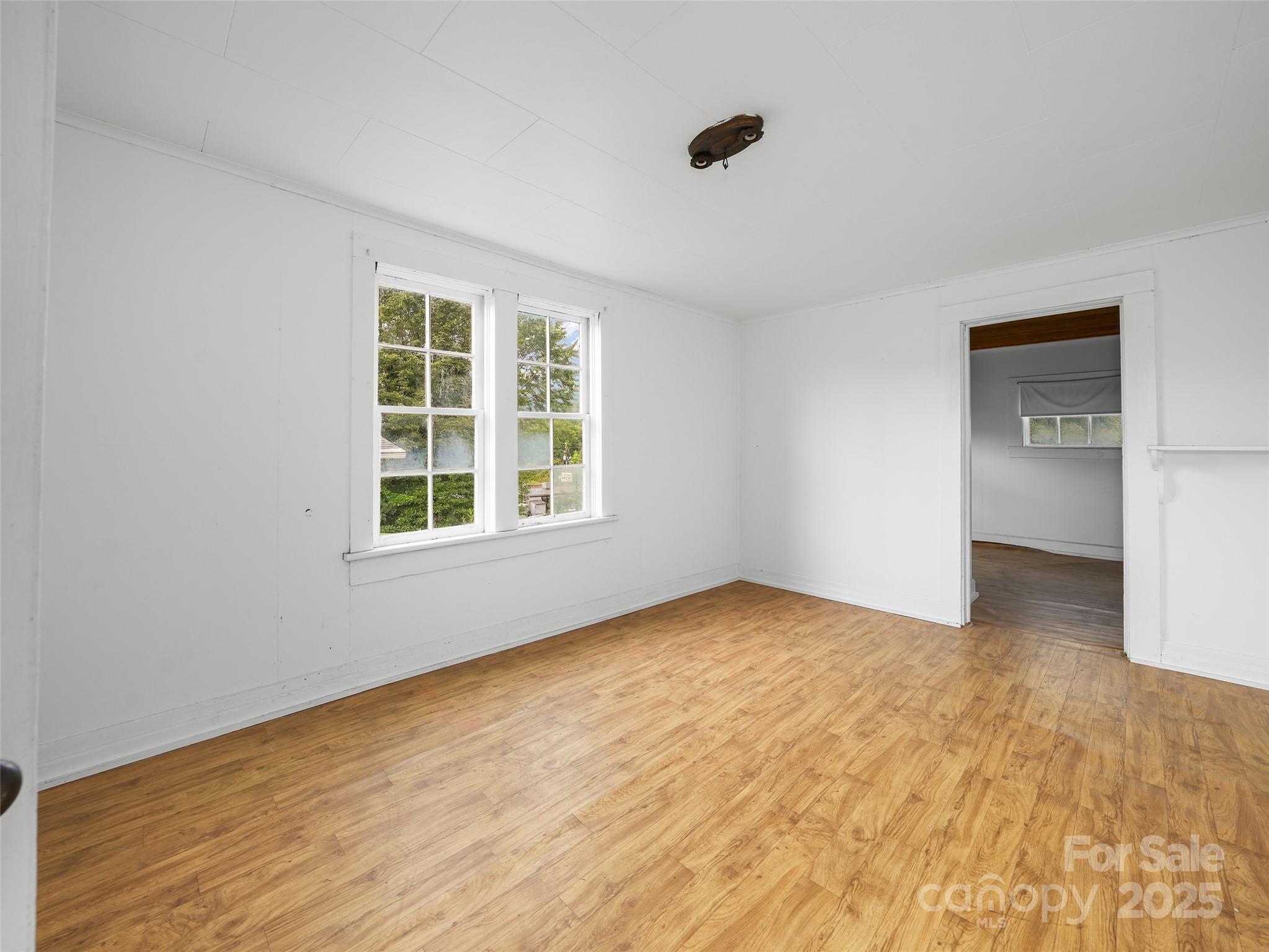 5 Noland Downs Road Waynesville, NC 28785 - Photo 24 of 33 a view of an empty room with a window and wooden floor