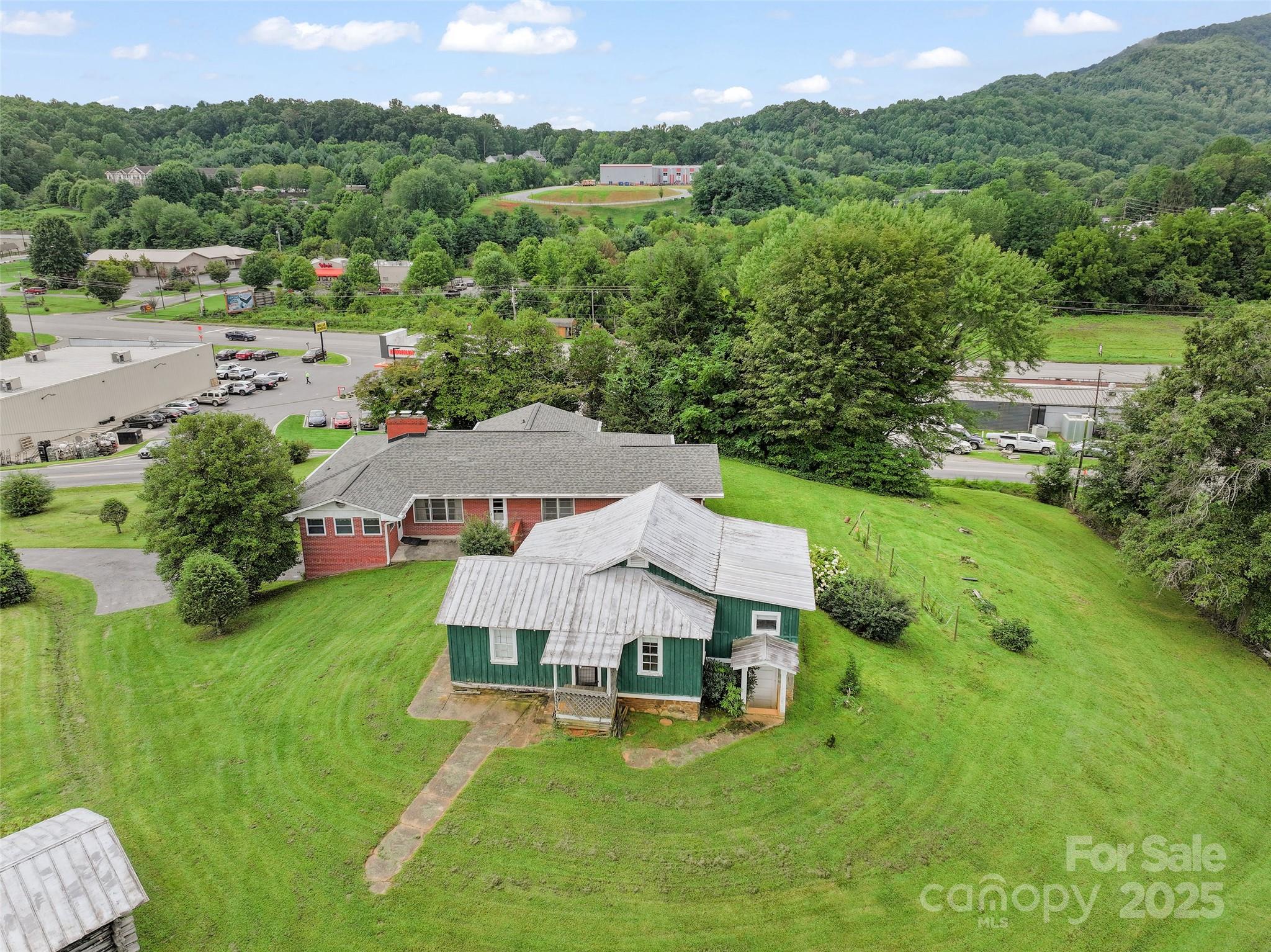 5 Noland Downs Road Waynesville, NC 28785 - Photo 3 of 33 an aerial view of a house with yard and green space