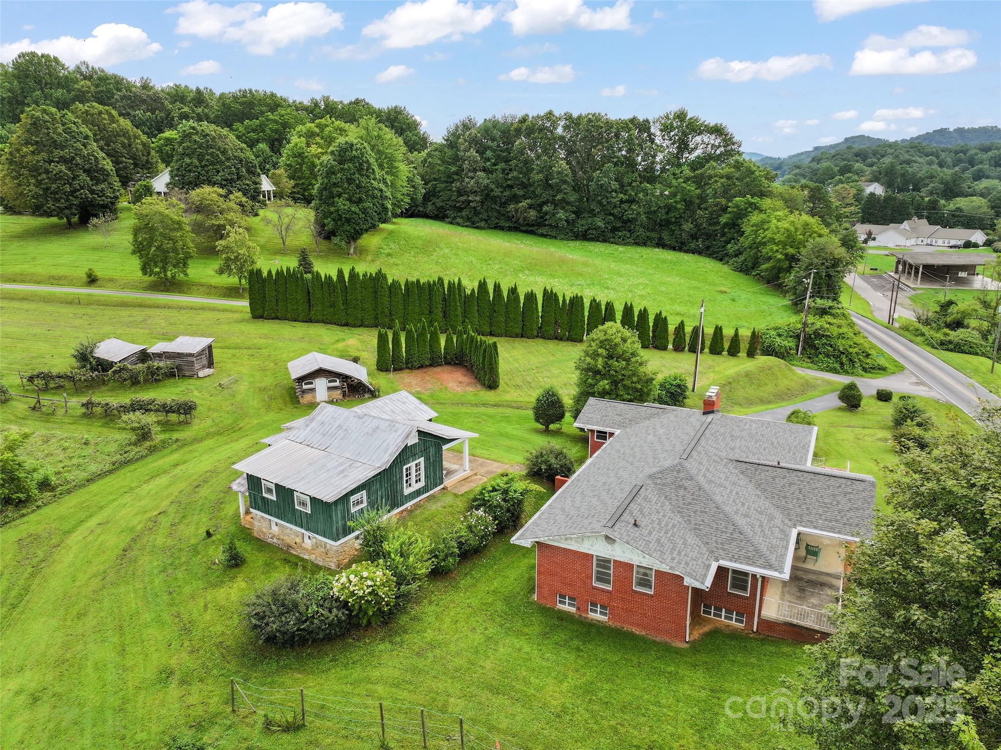 5 Noland Downs Road Waynesville, NC 28785 - Photo 31 of 33 an aerial view of a house with garden space and street view