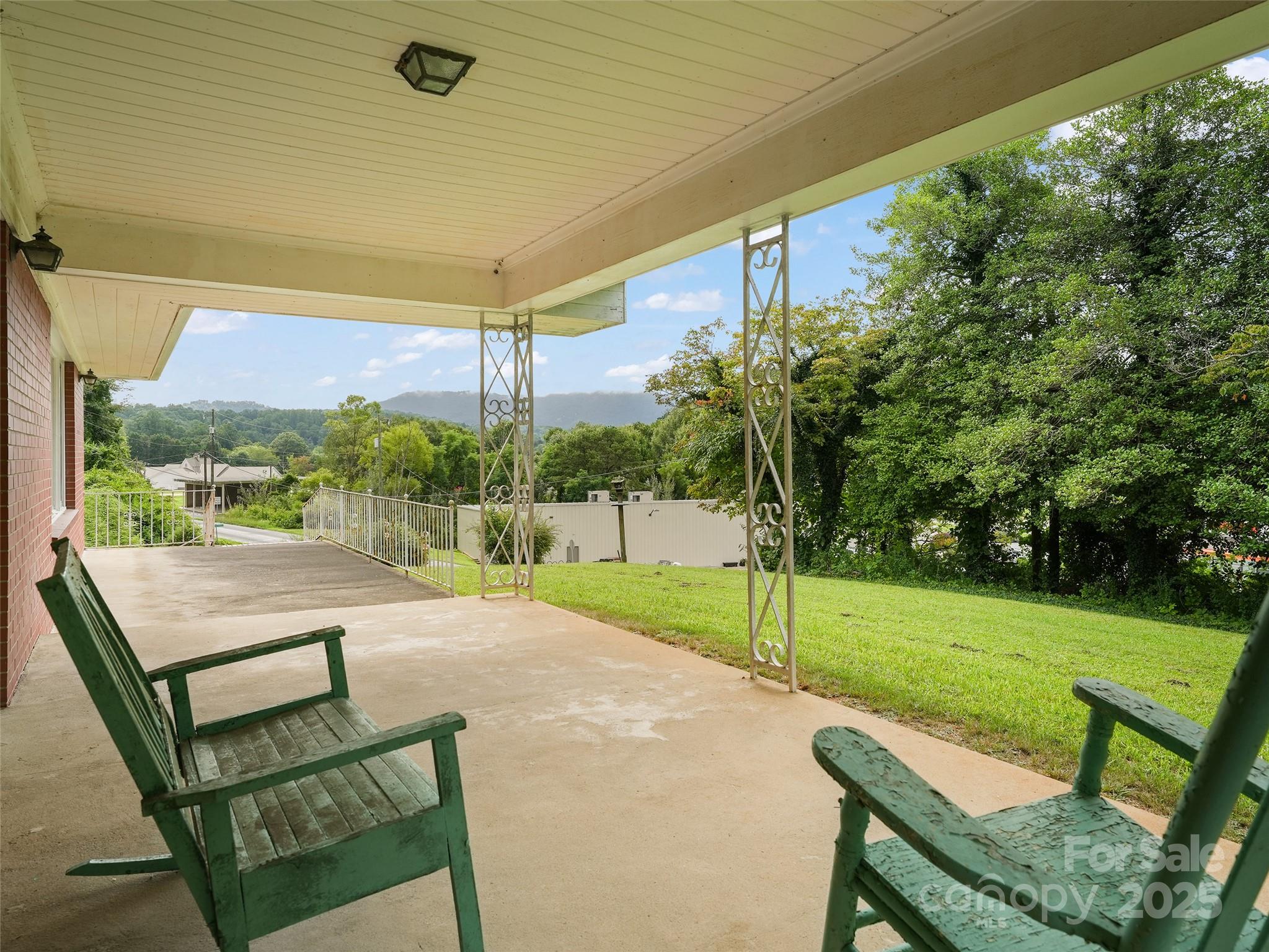 5 Noland Downs Road Waynesville, NC 28785 - Photo 4 of 33 a view of a porch with furniture and a yard