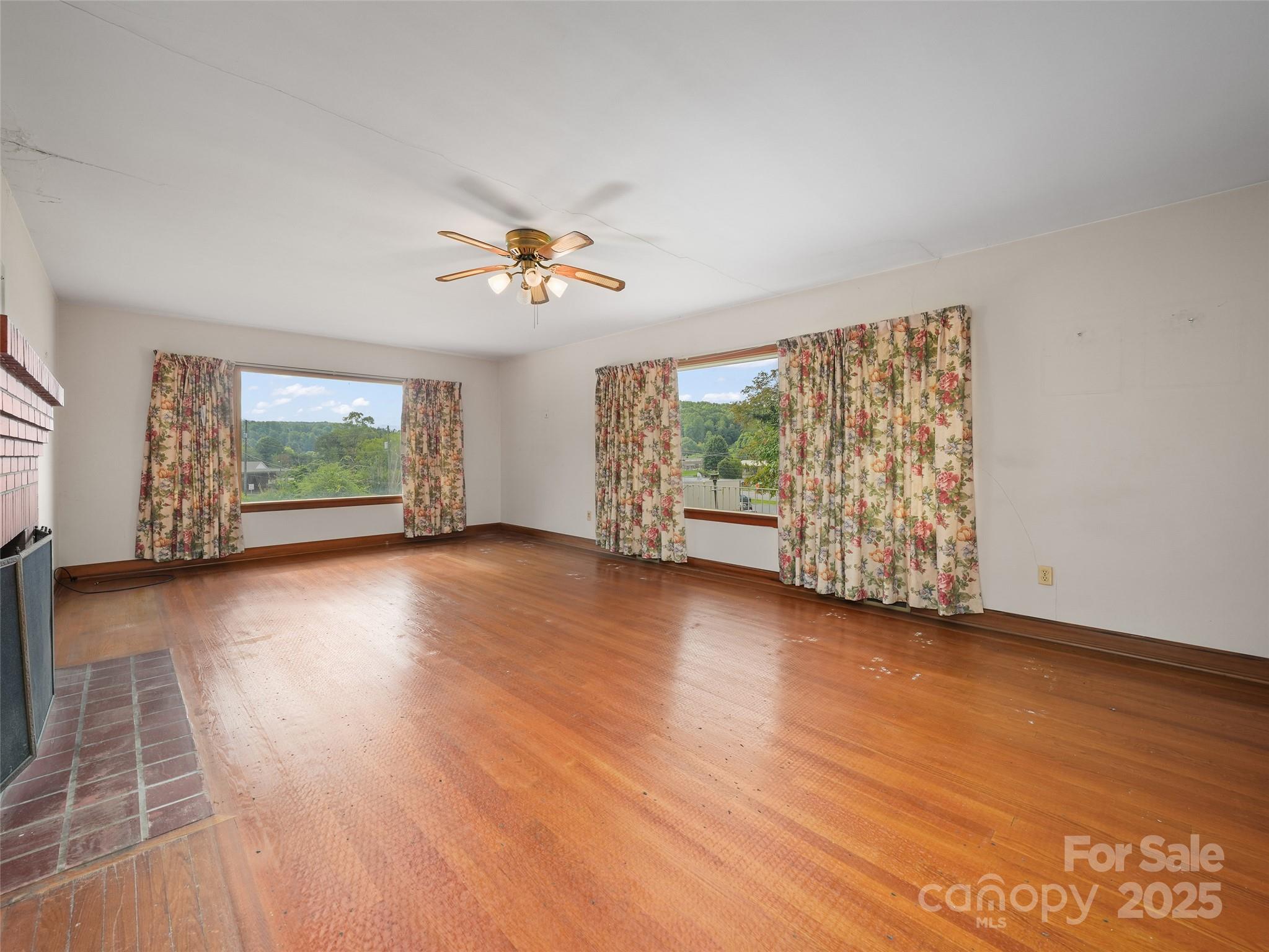 5 Noland Downs Road Waynesville, NC 28785 - Photo 7 of 33 wooden floor in an empty room with a window