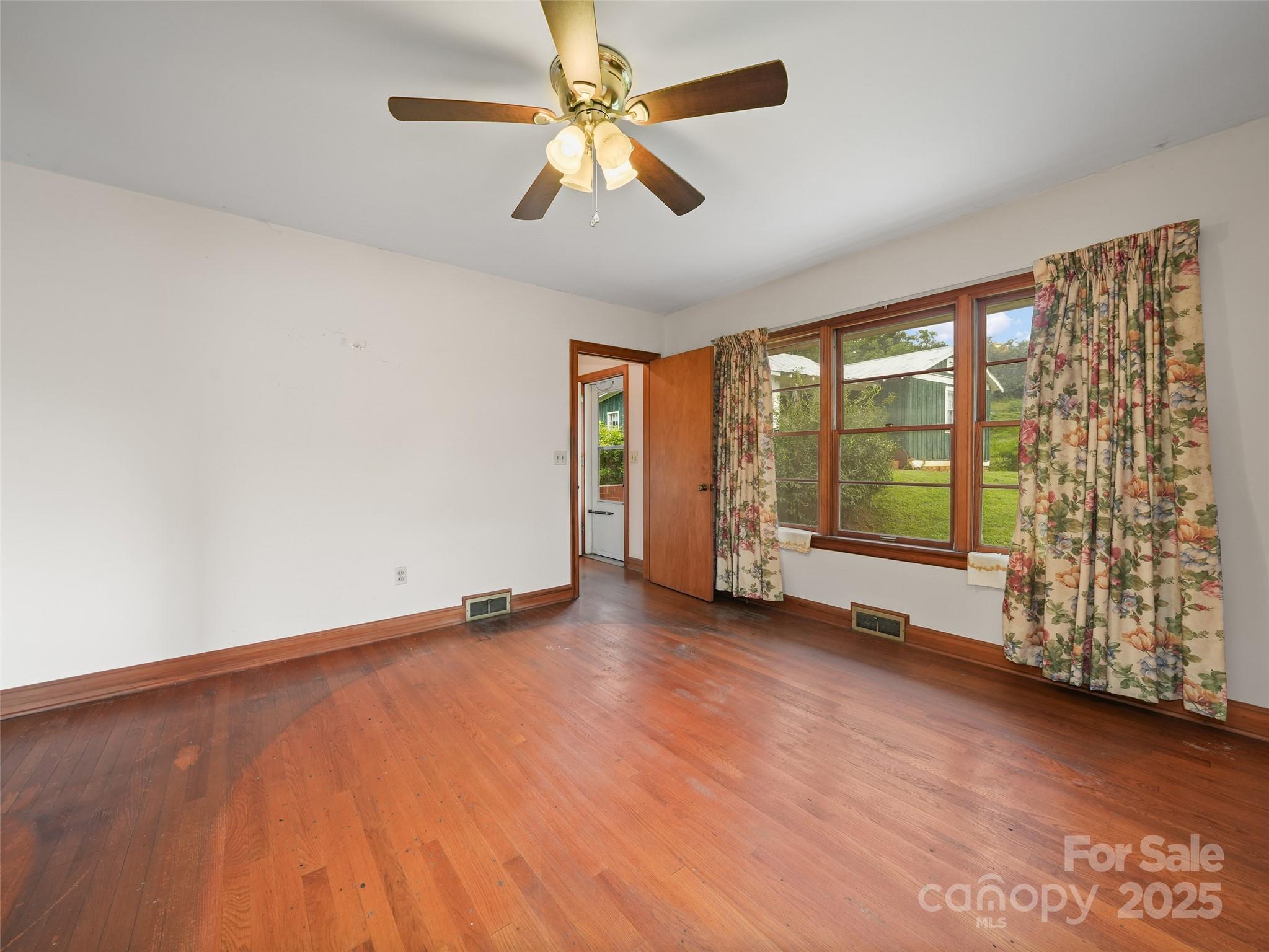 5 Noland Downs Road Waynesville, NC 28785 - Photo 10 of 33 wooden floor in an empty room with a window