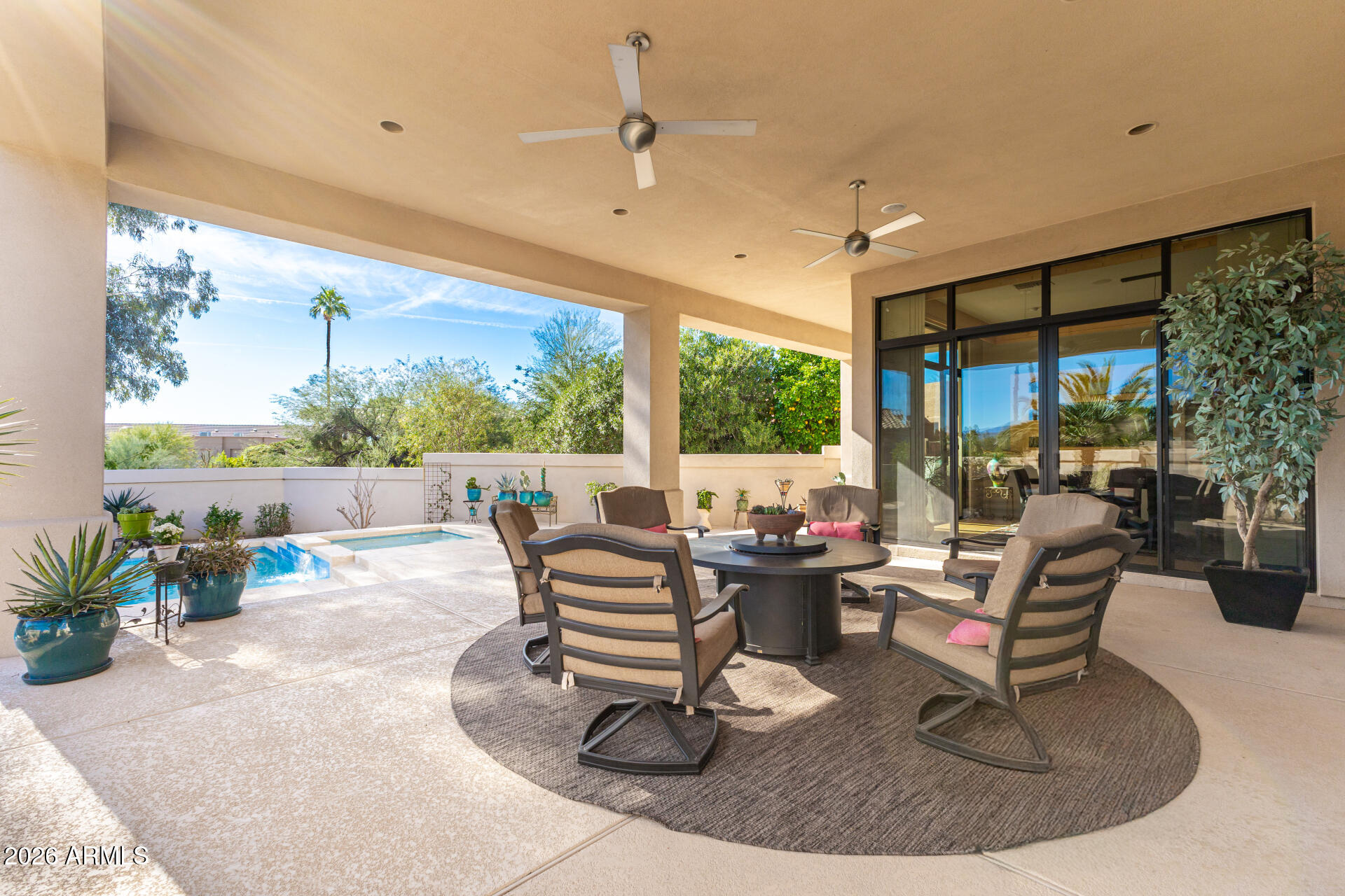 18567 East Paseo Verde Drive Rio Verde, AZ 85263 - Photo 30 of 47 a living room with patio furniture and a floor to ceiling window
