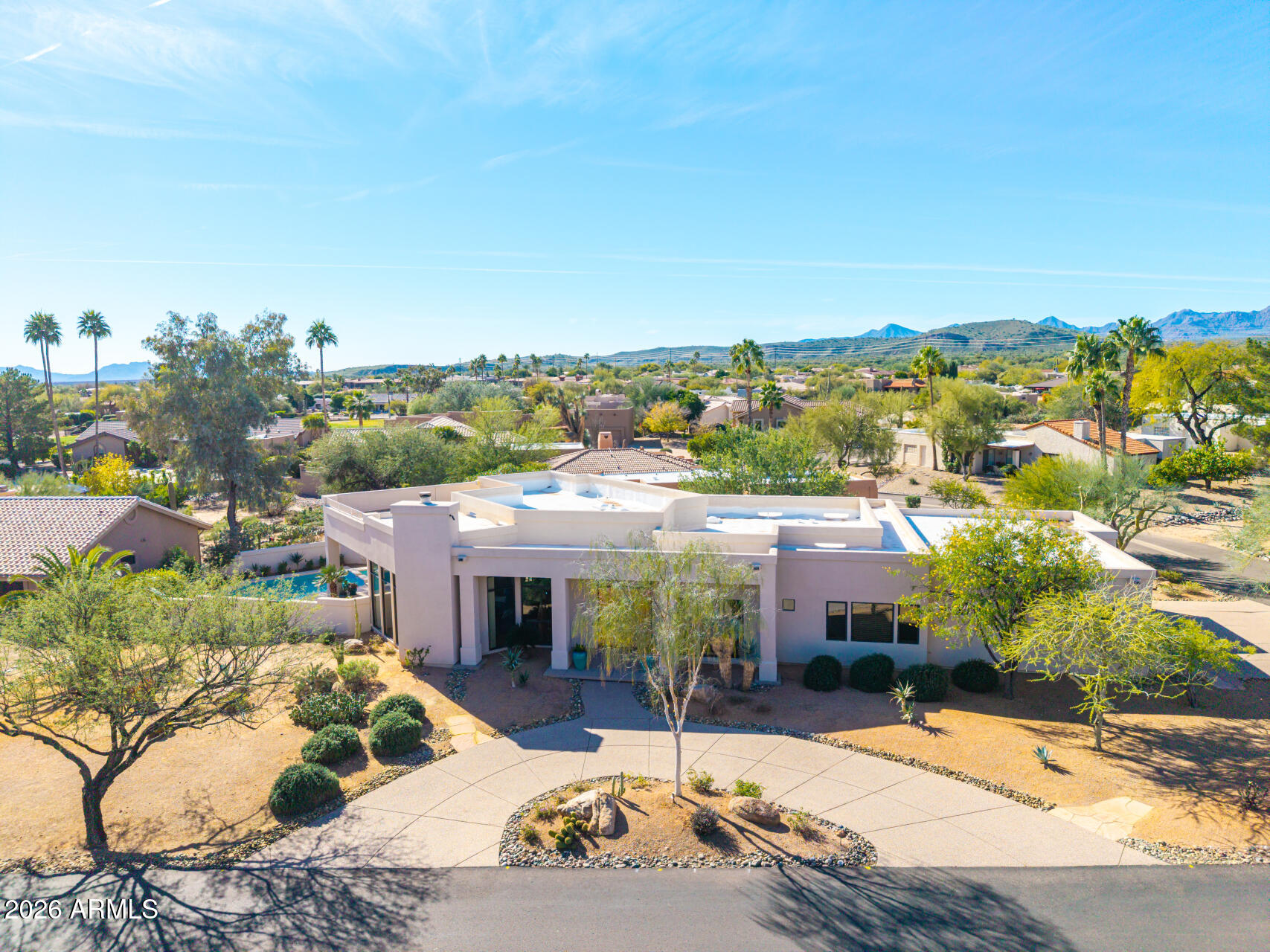 18567 East Paseo Verde Drive Rio Verde, AZ 85263 - Photo 44 of 47 a view of a patio with couches and a table and chairs under an umbrella