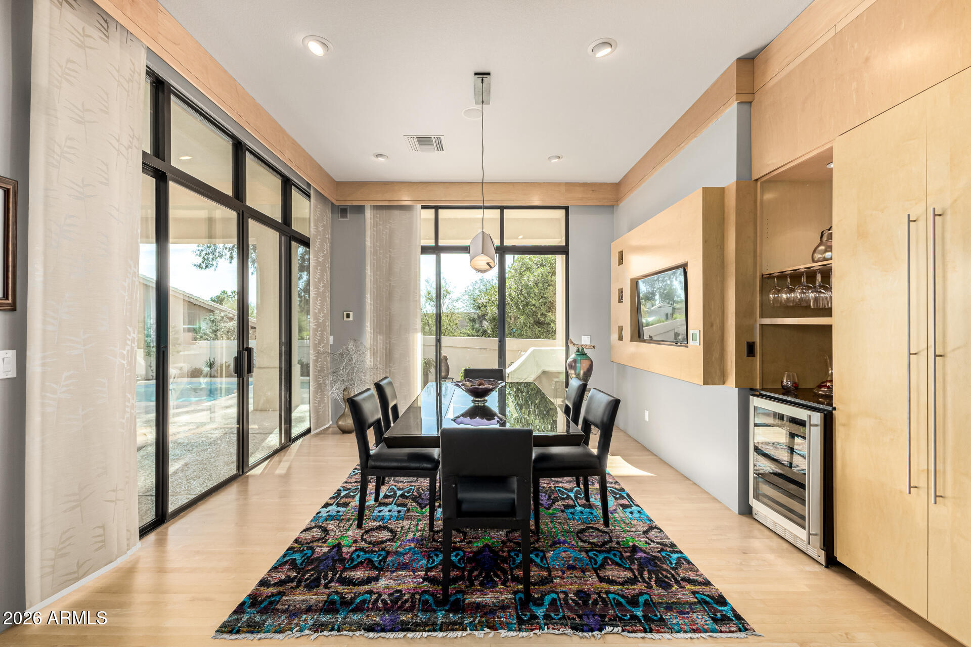 18567 East Paseo Verde Drive Rio Verde, AZ 85263 - Photo 10 of 47 a dining room with furniture wooden floor a rug a potted plant and a large window