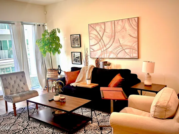 a living room with furniture and a potted plant