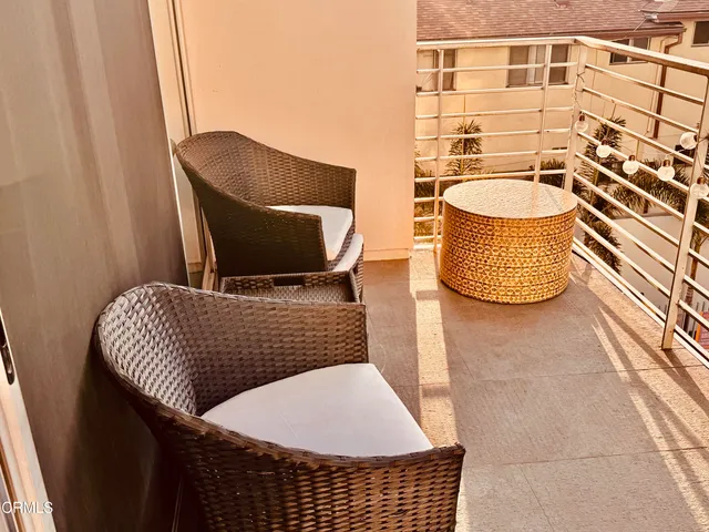 a living room with a rug and a chair