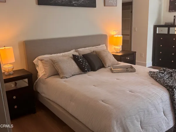 a large bed sitting in a bedroom next to a window