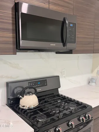 a stove top oven sitting inside of a kitchen