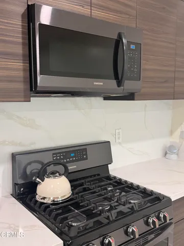 a stove top oven sitting inside of a kitchen