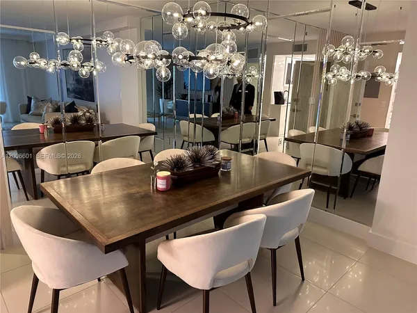 a view of a dining room with furniture and chandelier