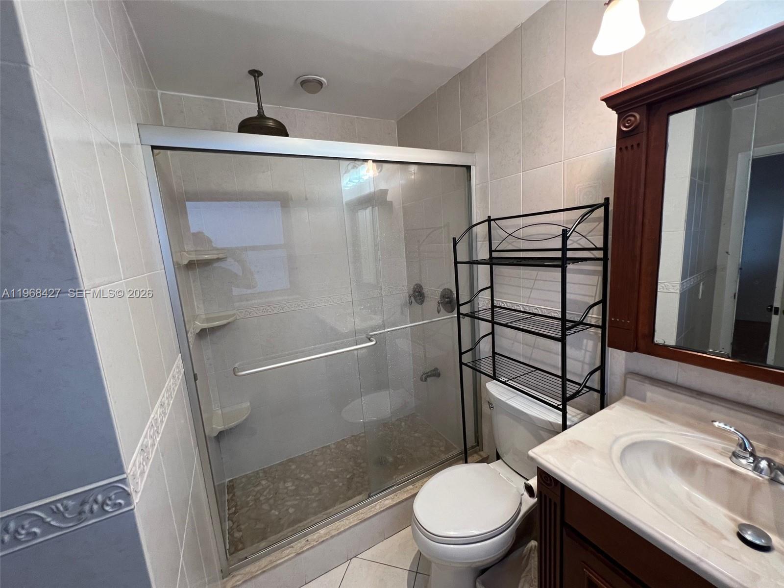344 Southwest 1st Street, Unit 6 Pompano Beach, FL 33060 - Photo 8 of 11 a bathroom with a sink toilet and shower