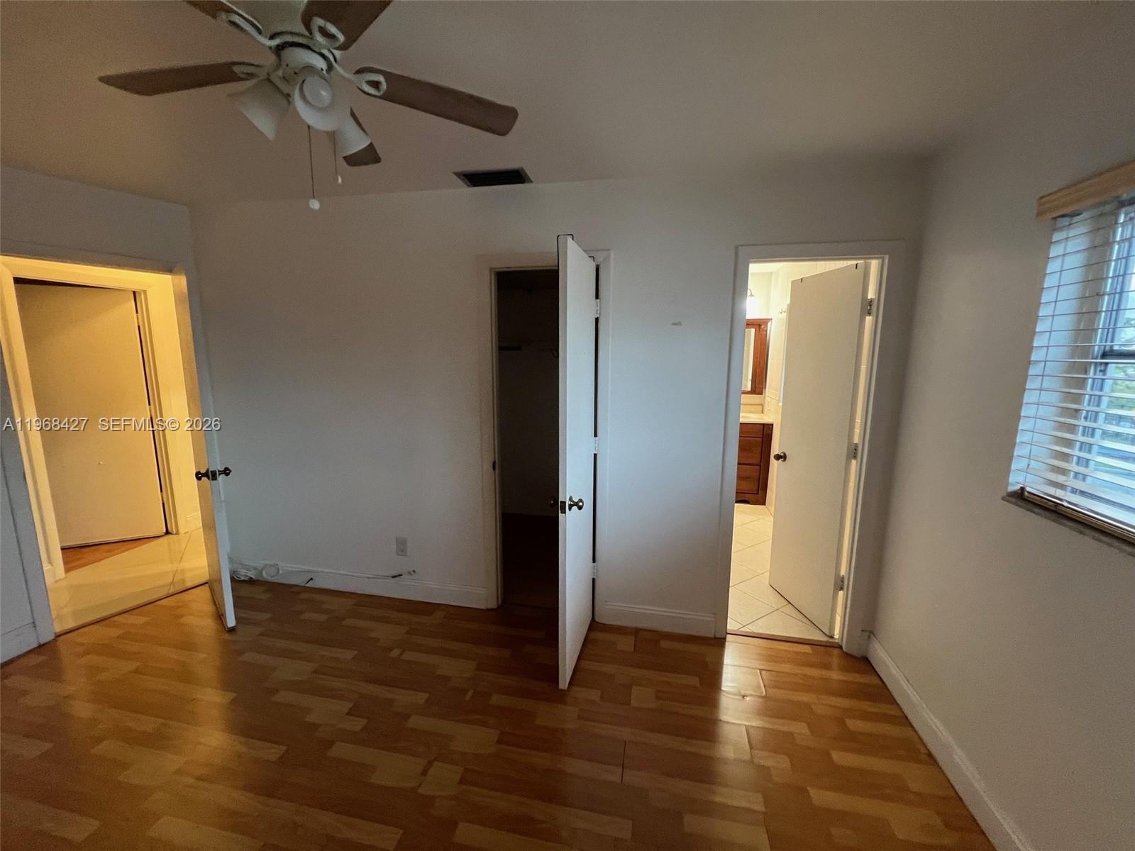 344 Southwest 1st Street, Unit 6 Pompano Beach, FL 33060 - Photo 10 of 11 an empty room with wooden floor closet and windows