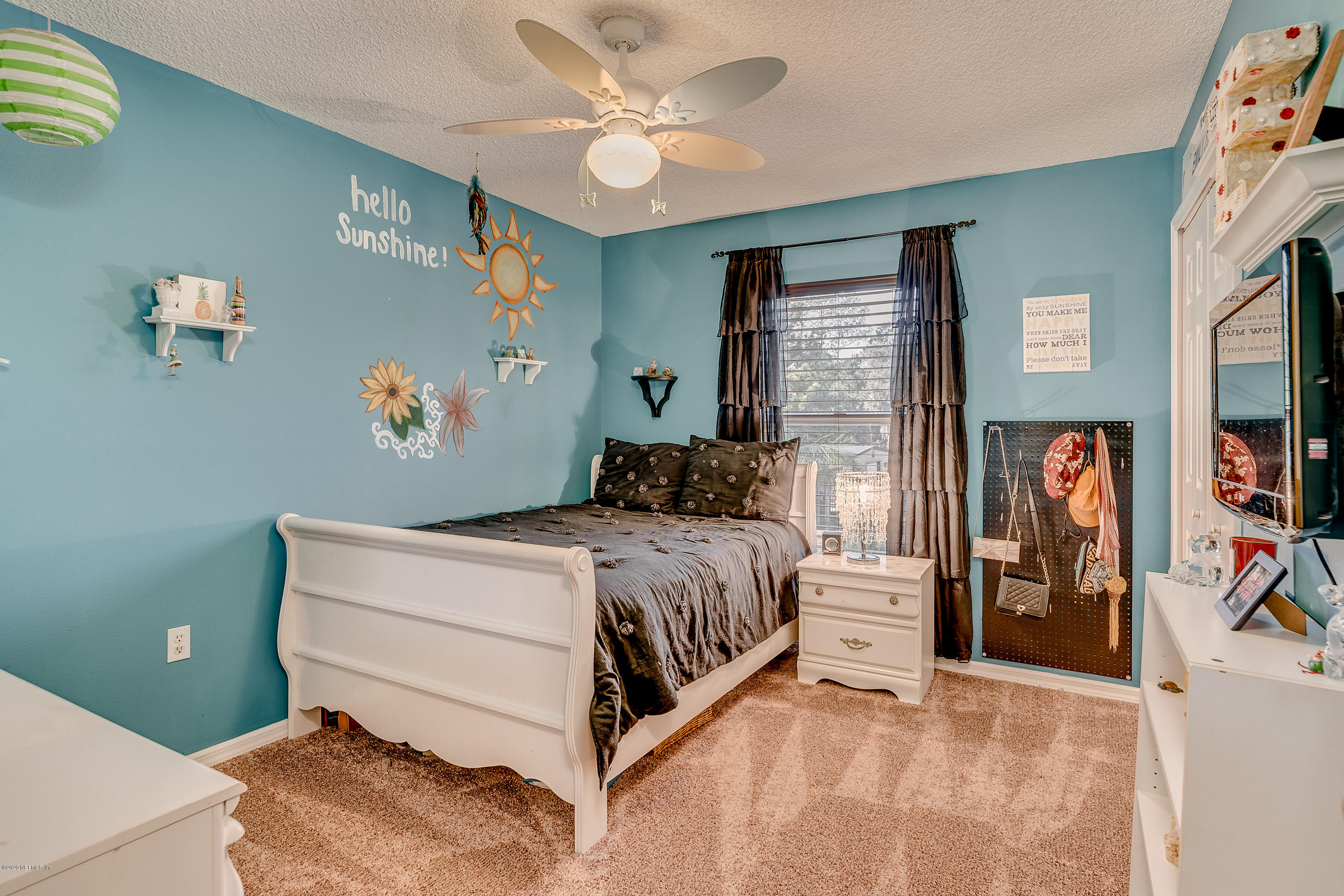 55567 Bear Run Road Callahan, FL 32011 - Photo 54 of 55 a bedroom with a bed and a chandelier