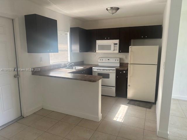 a kitchen with a sink a refrigerator and cabinets
