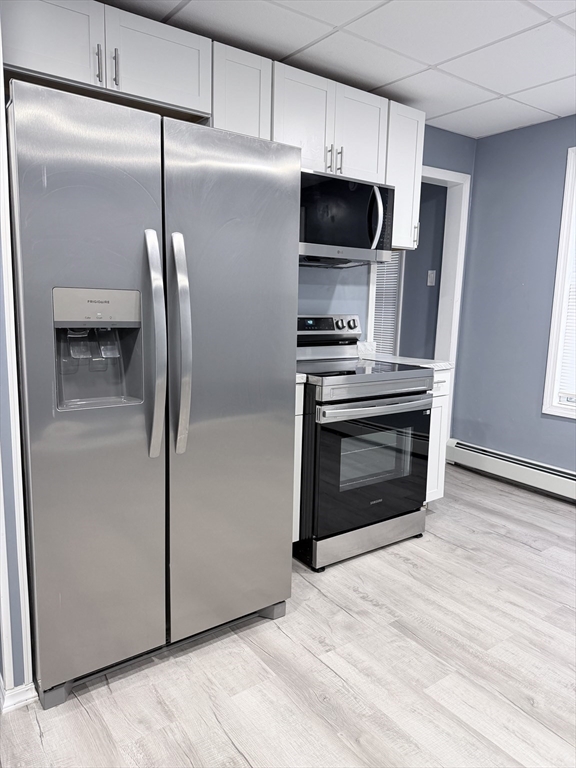 a kitchen with stainless steel appliances a refrigerator and a stove top oven
