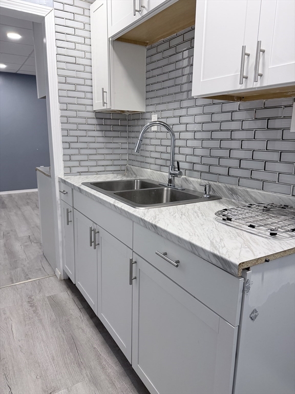 143 Cambridge Street, Unit 2 Worcester, MA 01603 - Photo 2 of 9 a kitchen with a sink and cabinets