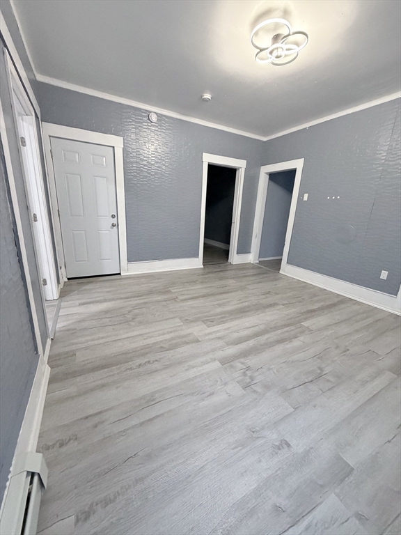 143 Cambridge Street, Unit 2 Worcester, MA 01603 - Photo 6 of 9 a view of an empty room with wooden floor