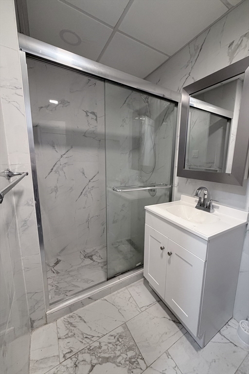 143 Cambridge Street, Unit 2 Worcester, MA 01603 - Photo 9 of 9 a bathroom with a shower sink and mirror