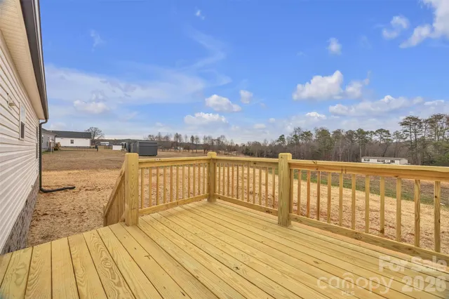 a view of balcony with wooden floor and fence