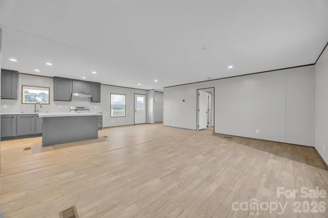 a view of kitchen with kitchen island and wooden floor