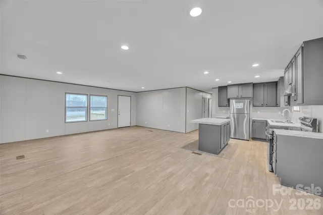 a open kitchen with white cabinets and white appliances