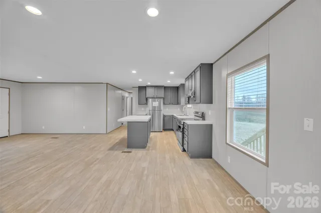 a view of a kitchen with a sink and a refrigerator