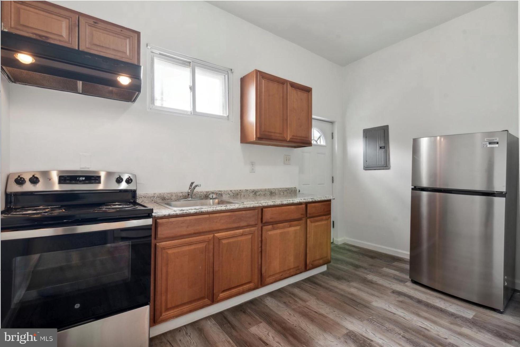 59 North 59th Street Philadelphia, PA 19139 - Photo 3 of 15 a kitchen with stainless steel appliances a stove a sink and a refrigerator