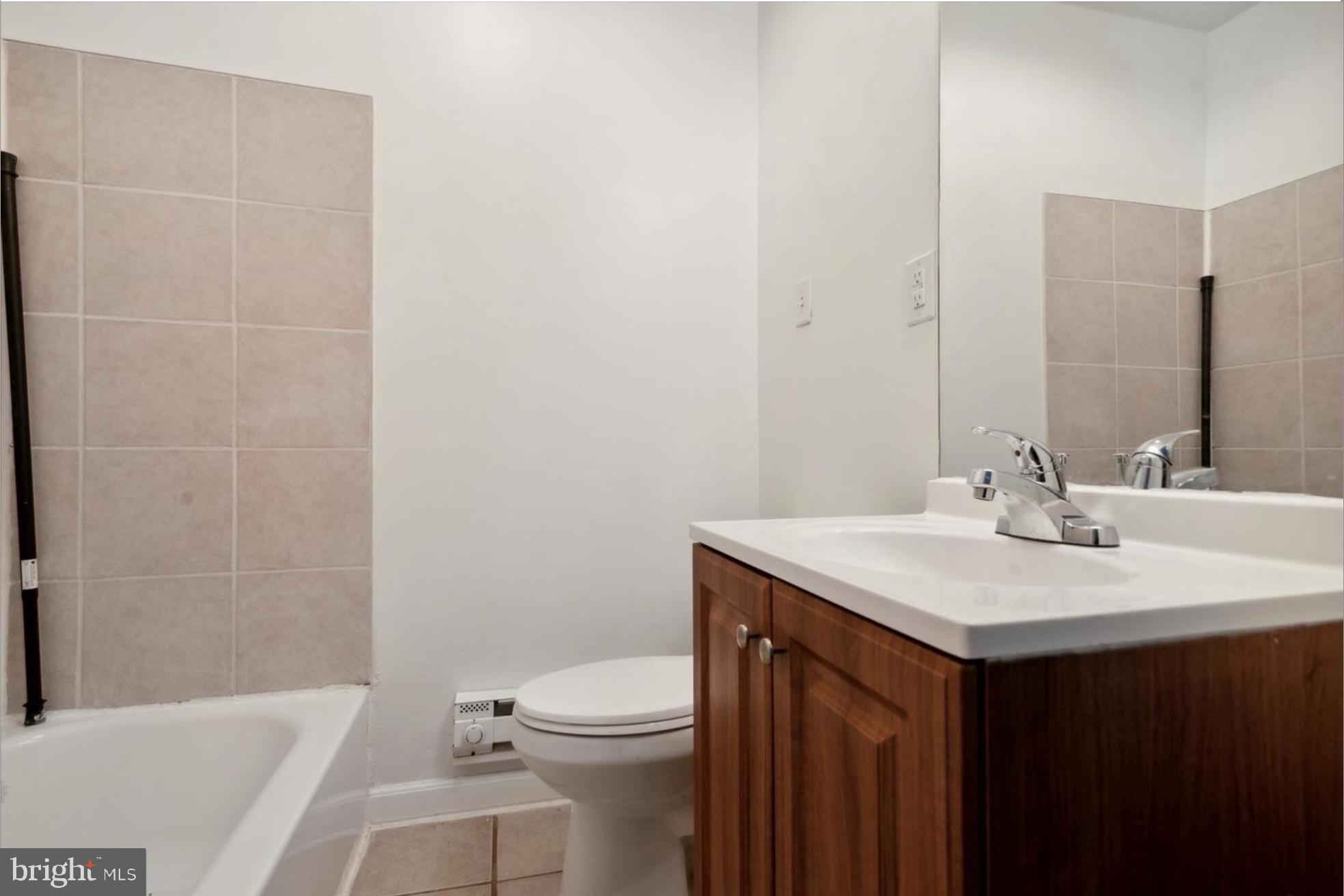 59 North 59th Street Philadelphia, PA 19139 - Photo 4 of 15 a bathroom with a sink a toilet and shower
