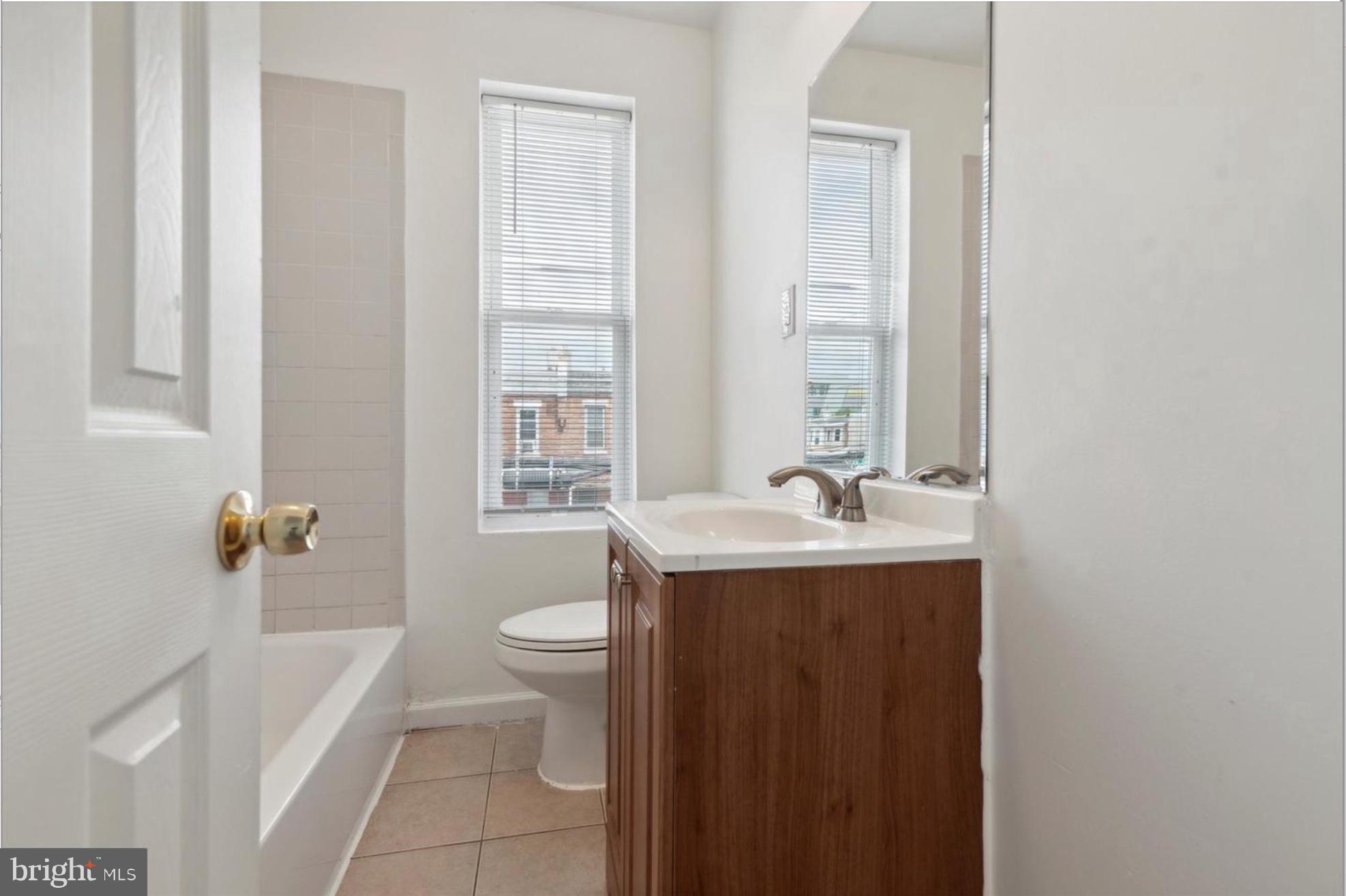 59 North 59th Street Philadelphia, PA 19139 - Photo 10 of 15 a bathroom with a granite countertop sink toilet and shower