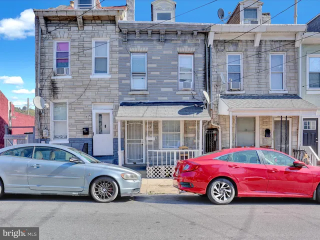 a front view of a house with parking space